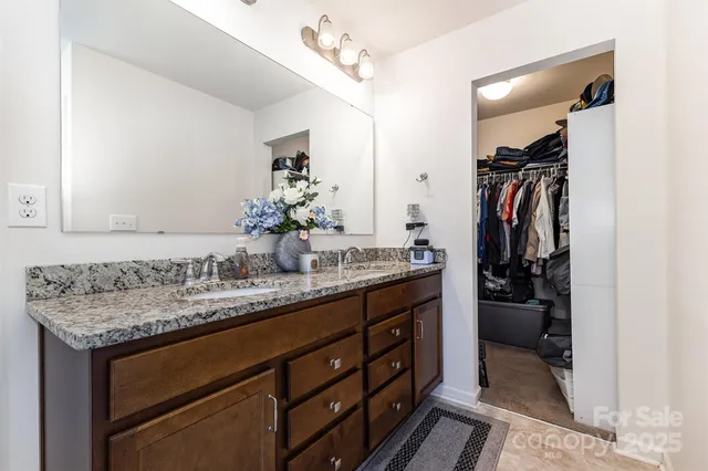 a bathroom with a sink vanity and a mirror