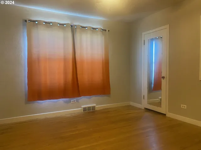 a view of room with window and hardwood