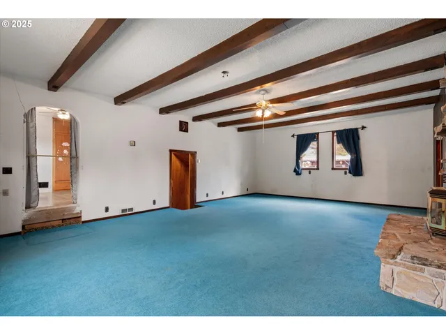 a view of a room with wooden floor and stairs