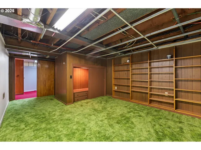 a view of an empty room with wooden shelves