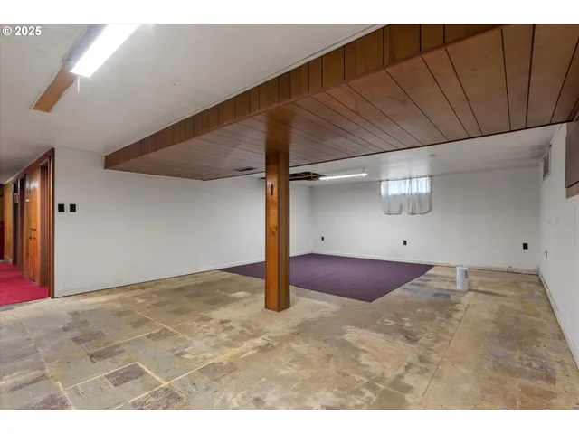 a view of a livingroom with a ceiling fan and window