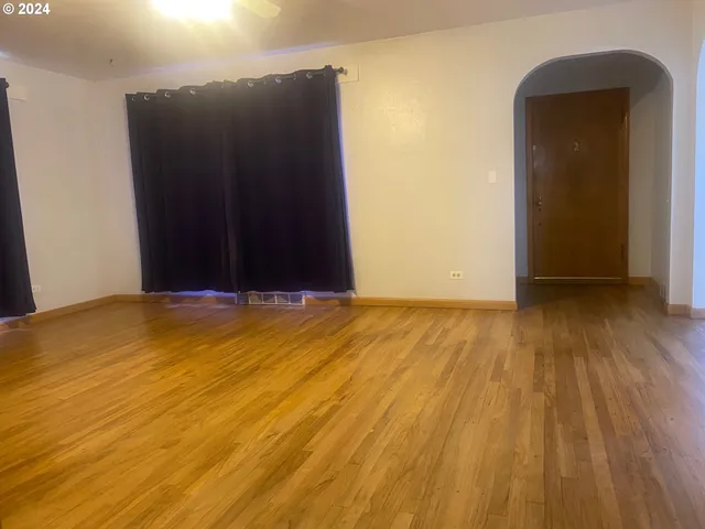 a view of a room with wooden floor