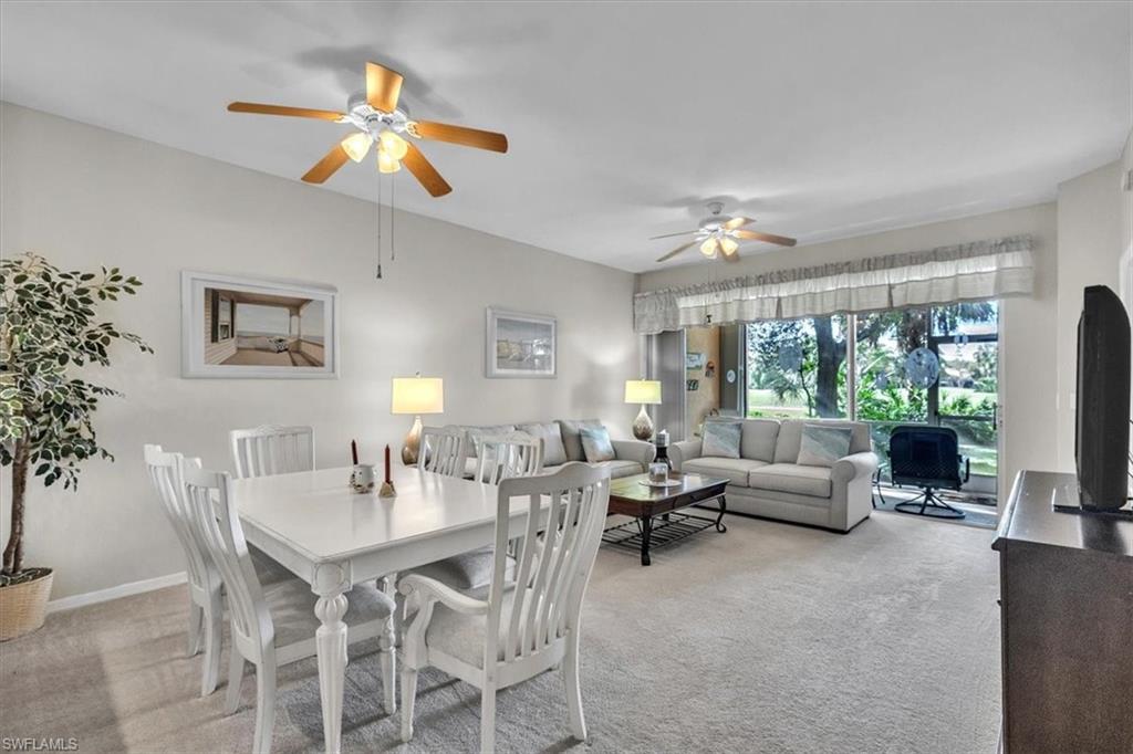 8075 Tiger Cove, Unit 1706 Naples, FL 34113 - Photo 2 of 50 Dining room with light colored carpet and ceiling fan