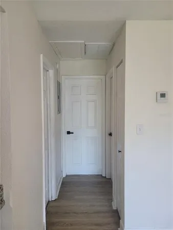 a view of a hallway with wooden floor