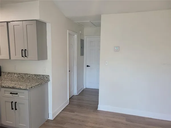 a view of a hallway with wooden floor