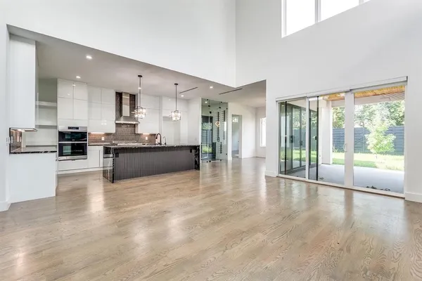 a big room with wooden floor and windows