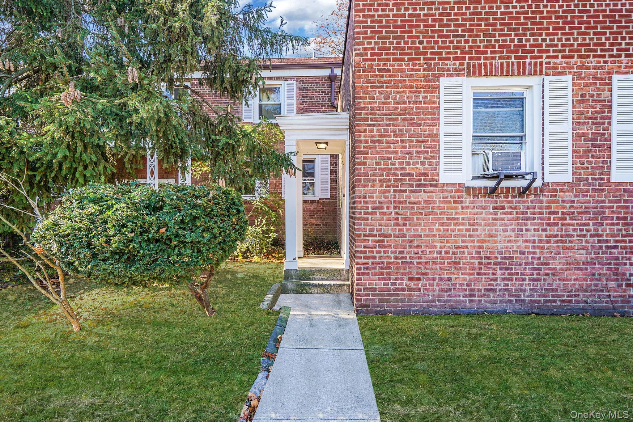 144-66 Village Road, Unit 75D Queens, NY 11435 - Photo 1 of 19 a front view of a house with a garden