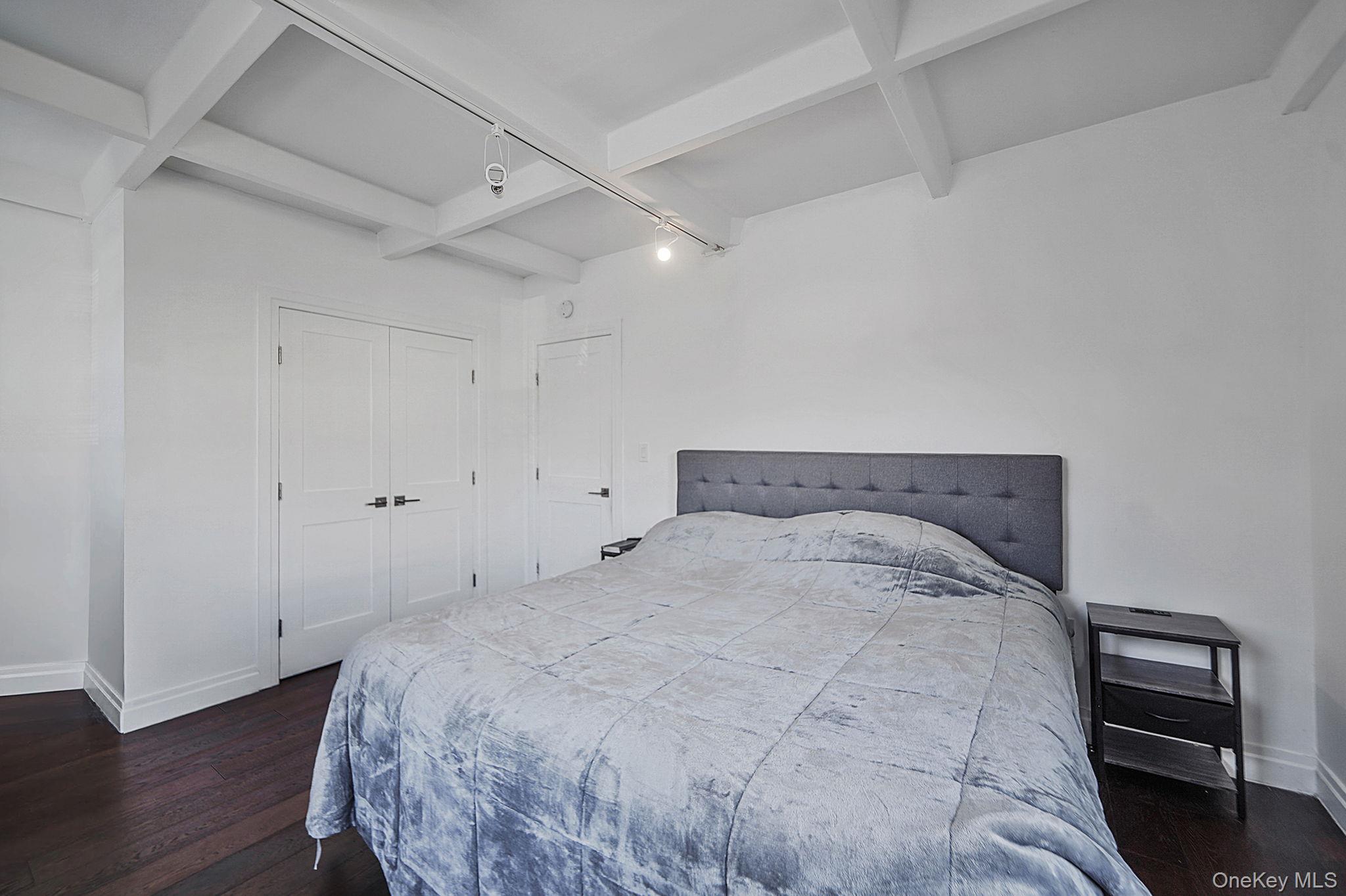 144-66 Village Road, Unit 75D Queens, NY 11435 - Photo 10 of 19 a bedroom with a bed and wooden floor