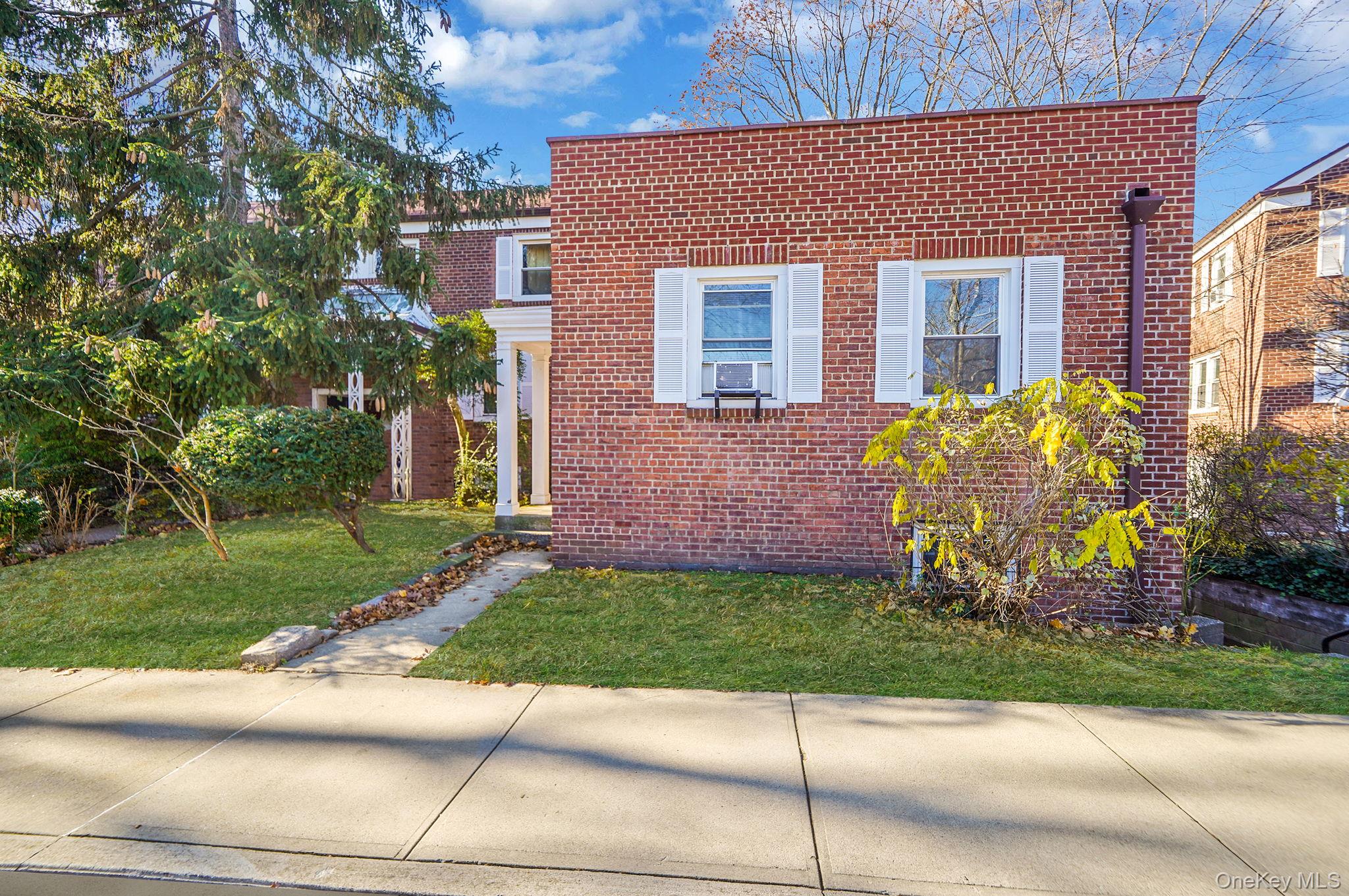 144-66 Village Road, Unit 75D Queens, NY 11435 - Photo 3 of 19 a front view of a house with garden