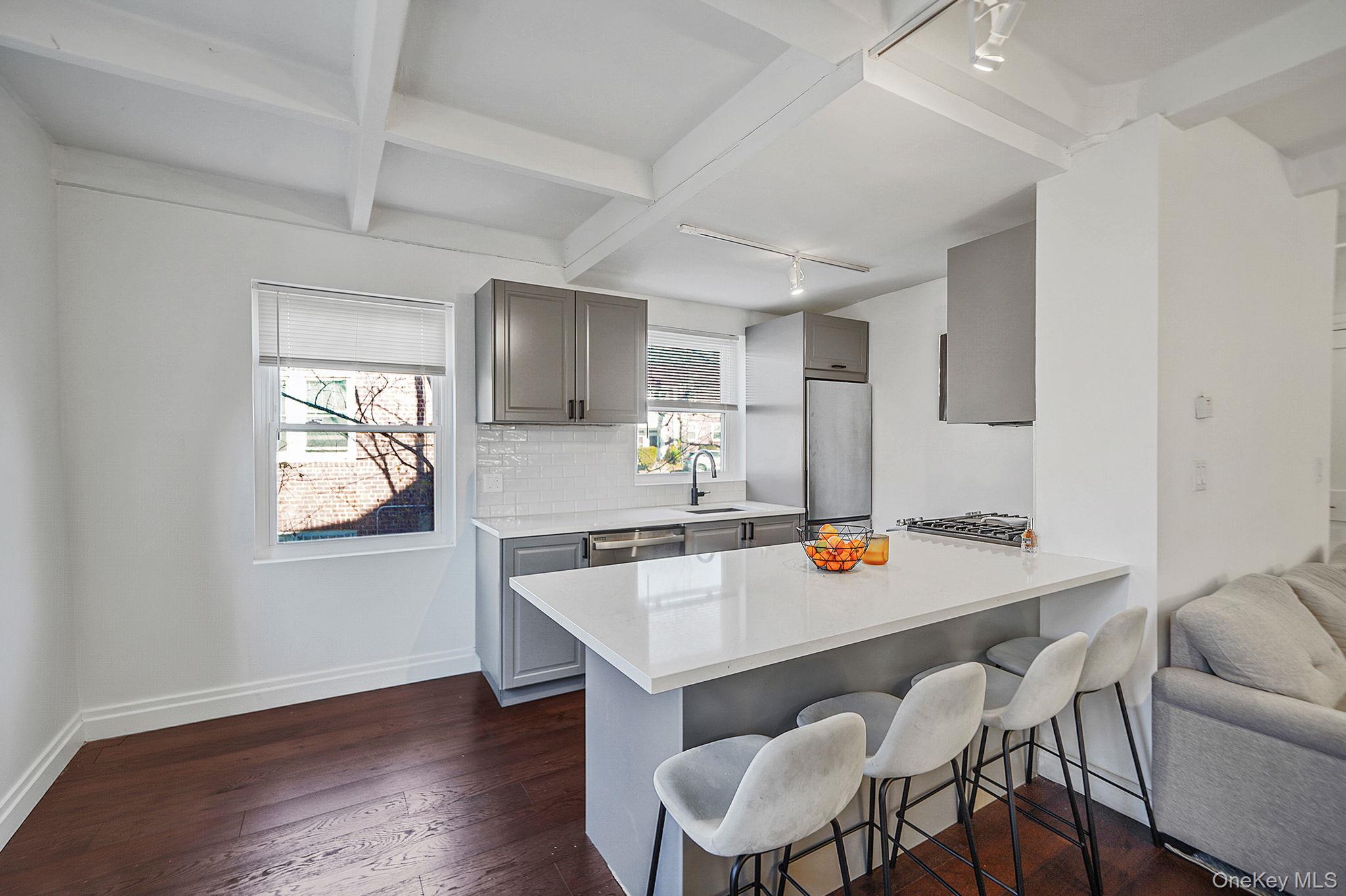 144-66 Village Road, Unit 75D Queens, NY 11435 - Photo 5 of 19 a kitchen with a wooden floor and breakfast area