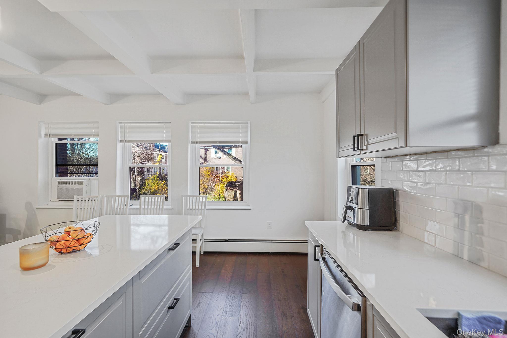 144-66 Village Road, Unit 75D Queens, NY 11435 - Photo 7 of 19 a view of a kitchen with furniture and flat screen tv