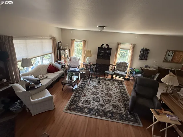 a living room with furniture rug and a window