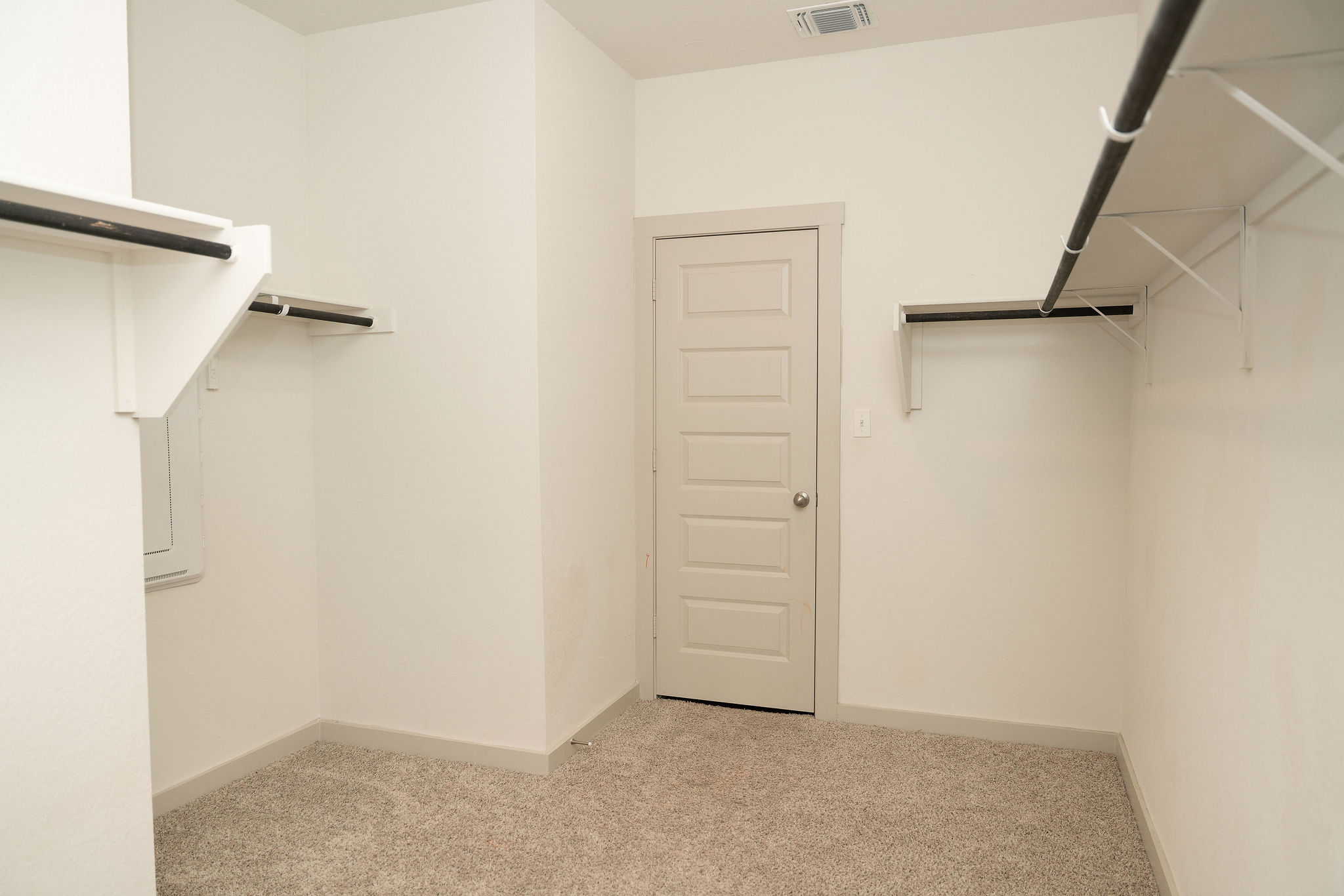 120 Wichita River Road Hutto, TX 78634 - Photo 20 of 31 Ample hanging rods and soft carpeting define this functional walk-in closet space.