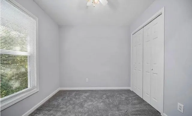 a view of an empty room with a window