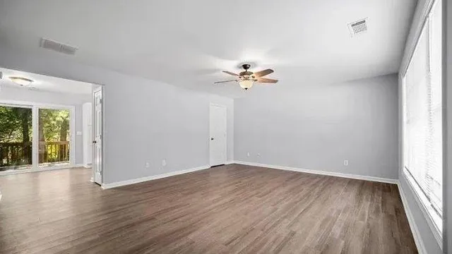 wooden floor in an empty room with a window
