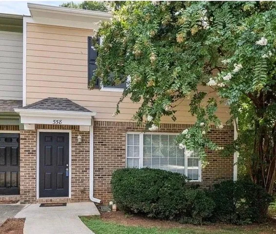 a view of a house with a tree