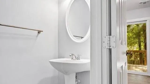 a bathroom with a sink a mirror and a shower