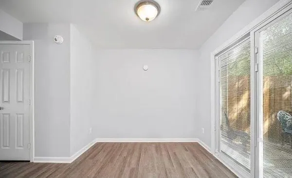 a view of a room with wooden floor and iron gate