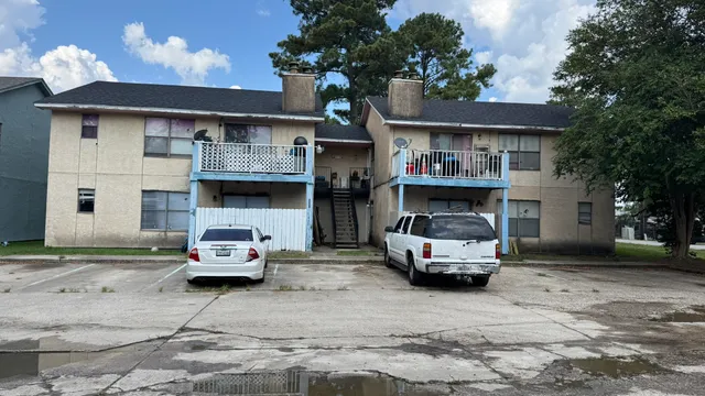 a car parked in front of white house