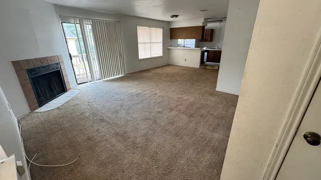 a view of a kitchen with a sink and a refrigerator