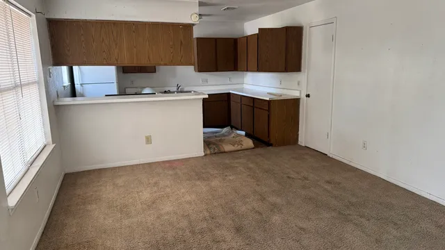 a kitchen with a sink a stove and cabinets