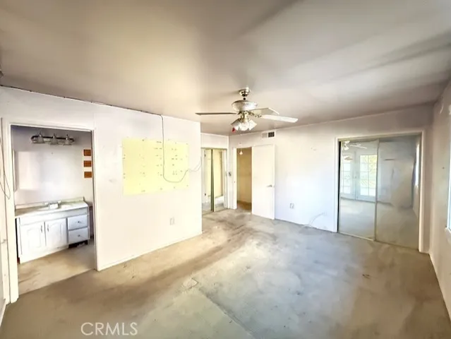 a bathroom with a granite countertop sink and a large mirror