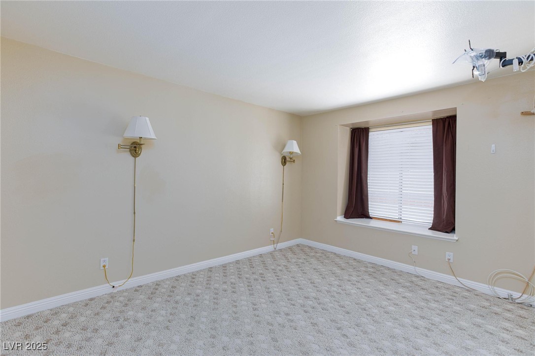 7300 West Pirates Cove Road, Unit 2038 Las Vegas, NV 89145 - Photo 11 of 26 Spare room featuring baseboards and carpet flooring