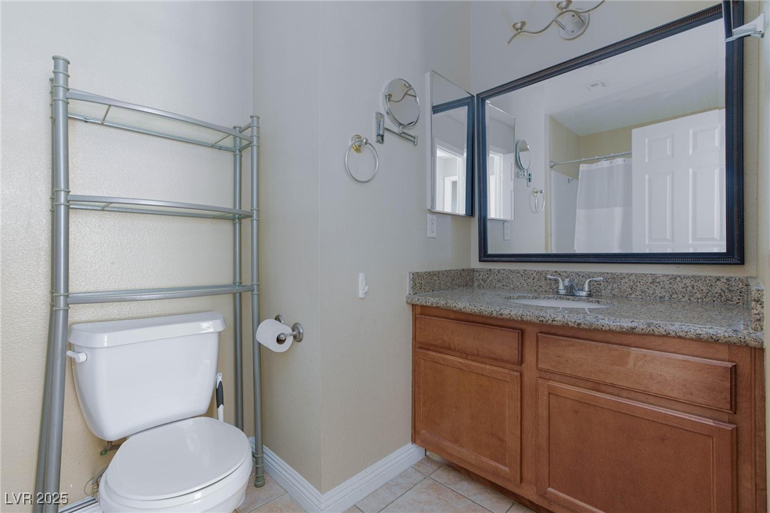 7300 West Pirates Cove Road, Unit 2038 Las Vegas, NV 89145 - Photo 14 of 26 Bathroom with vanity, light tile patterned floors, and curtained shower