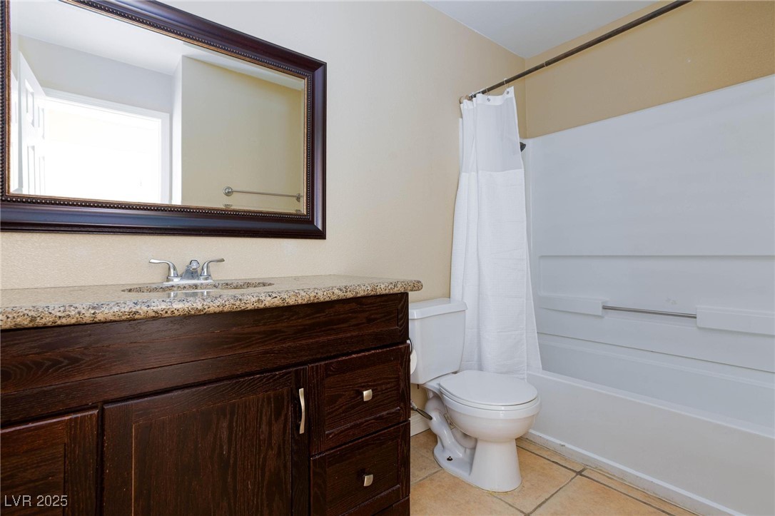 7300 West Pirates Cove Road, Unit 2038 Las Vegas, NV 89145 - Photo 18 of 26 Full bathroom featuring light tile patterned floors, vanity, and shower / bath combo