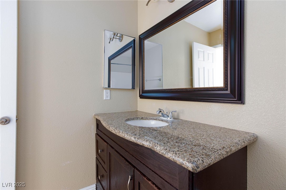 7300 West Pirates Cove Road, Unit 2038 Las Vegas, NV 89145 - Photo 19 of 26 Bathroom featuring vanity and a textured wall