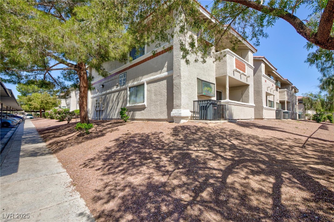 7300 West Pirates Cove Road, Unit 2038 Las Vegas, NV 89145 - Photo 26 of 26 View of home's exterior with stucco siding
