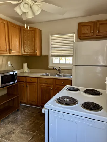 a kitchen with a sink a stove and cabinets