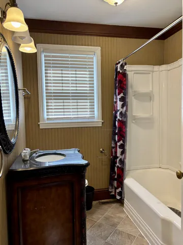 a bathroom with a bathtub and a sink