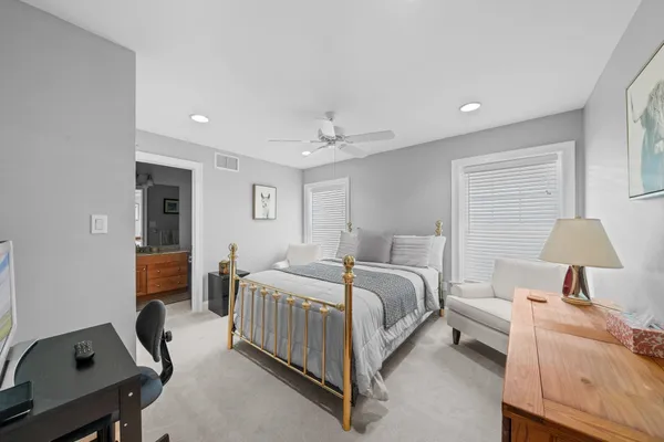 a bedroom with a bed and a desk