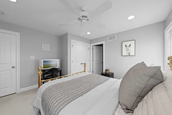 a bedroom with a large bed and a tv