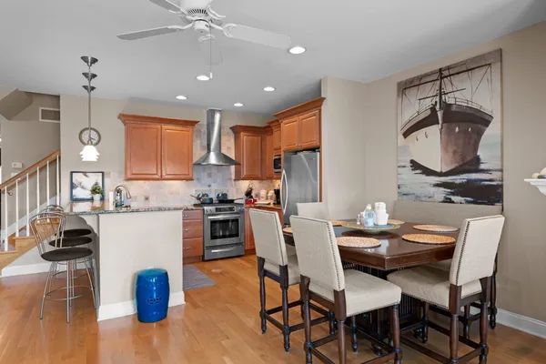 a kitchen with a table chairs a sink dishwasher and cabinets