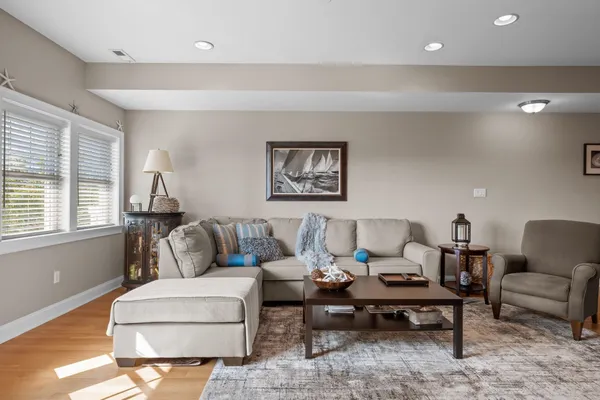a living room with furniture a rug and a large window