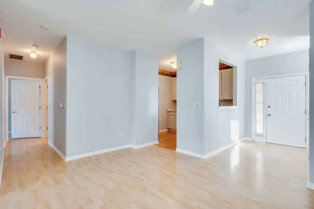 a view of an empty room with wooden floor