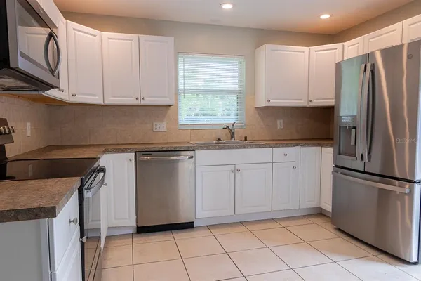 a view of an entryway and kitchen view