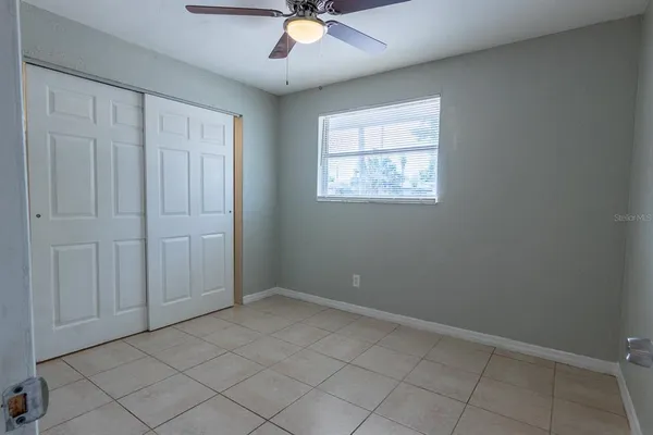 an empty room with cabinet and mirrors
