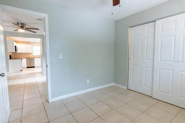 a view of kitchen with a sink cabinets and window
