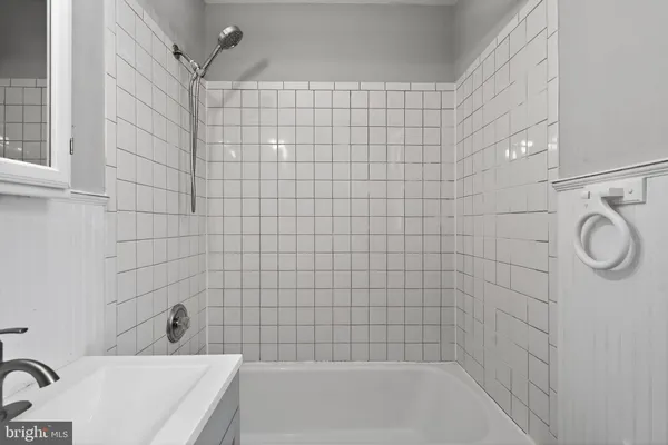 a bathroom with a bathtub and shower