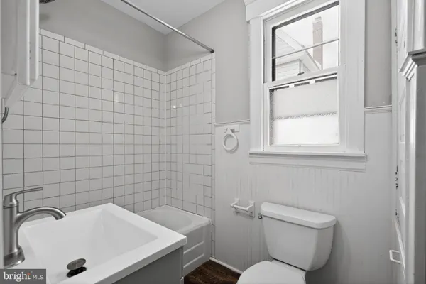 a bathroom with a sink a toilet and mirror