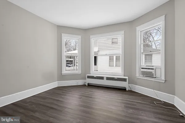 a view of a room with wooden floor and windows