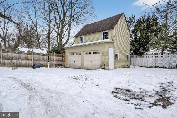 a view of a house with a yard covered in snow