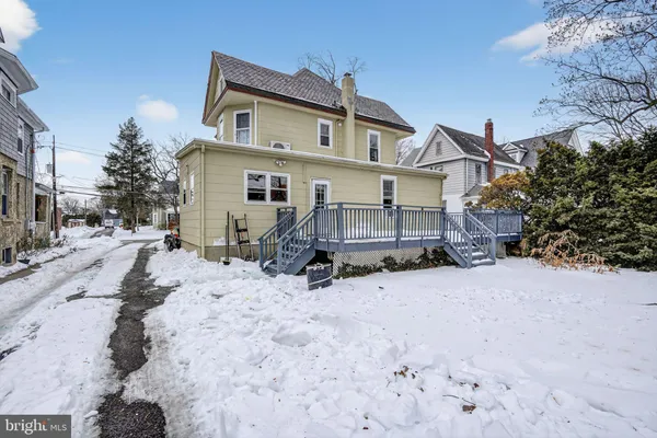 a view of a house with a yard covered in snow