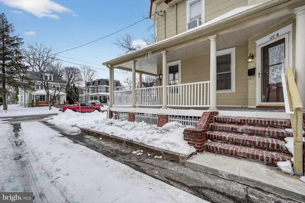 a front view of a house with a road