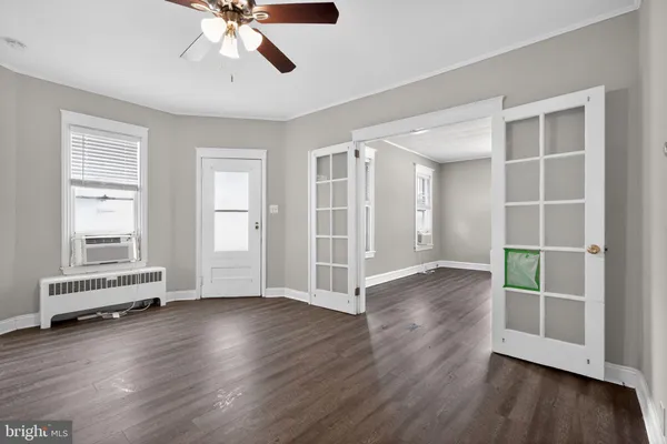 wooden floor in an empty room with a window