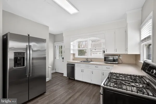 a kitchen with stainless steel appliances a refrigerator sink and stove