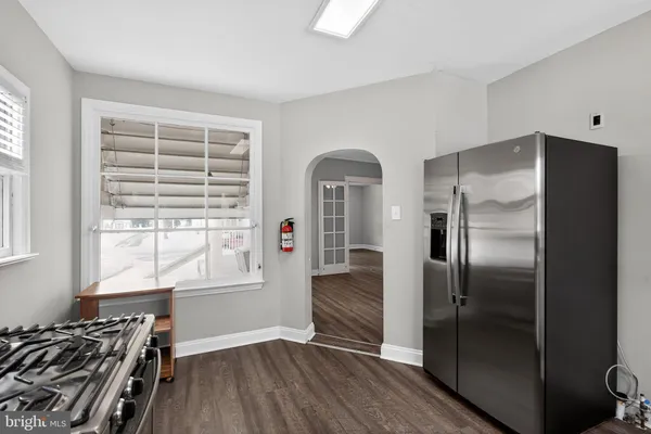 a kitchen with stainless steel appliances a refrigerator and a stove top oven
